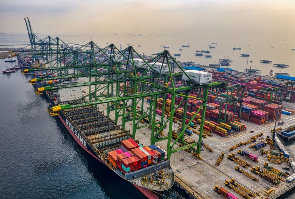 Container ships and gantry cranes at a working ocean freight terminal in North Jakarta